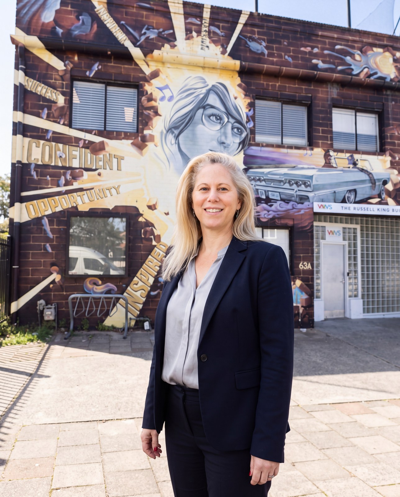 Dr Terri Said, Principal, in front of the WAYS Russell King Building