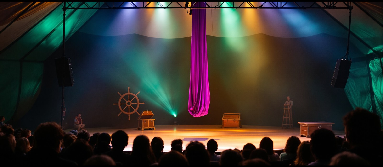 The circus tent stage set before the show, with aerial silk, treasure chest and ship's wheel