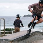Children riding scooters outside the WAYS centre in North Bondi